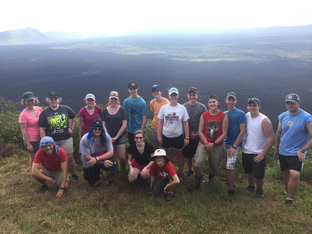 Group poses together on a mountain